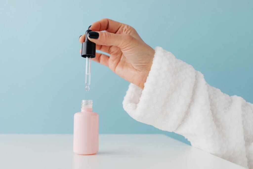 Close up of a skincare serum with a glass dropper